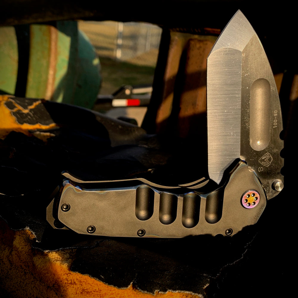 Praetorian Ti - S35VN Satin Tanto Blade PVD Handles w/Flamed Pinstriping Flamed Ti Pivot/Spacers w/PVD Screws Brushed/Flamed Clip Breaker